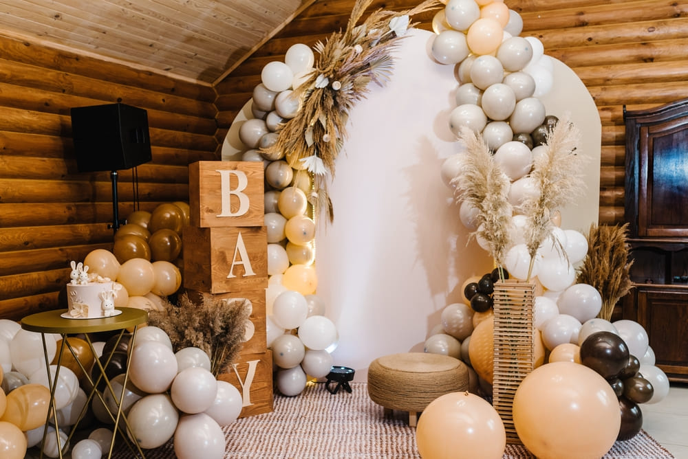 Elegant baby shower decorations with pastel balloons and table setup